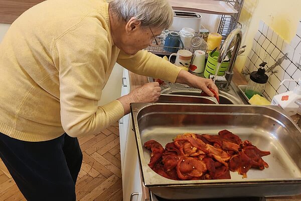 Geröstete Paprika werden am Waschbecken abgespült